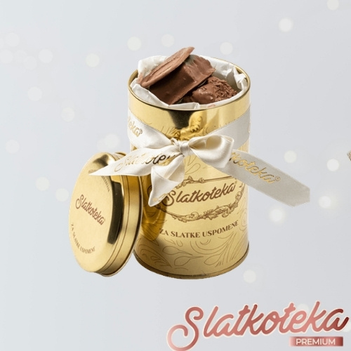 Brownie mini bites u metalnoj kutiji na sivoj pozadini sa šljokicama